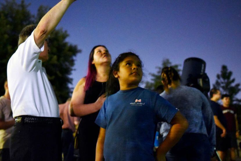 People look at the night sky at an event hosted by the Texas Astronomical Society.