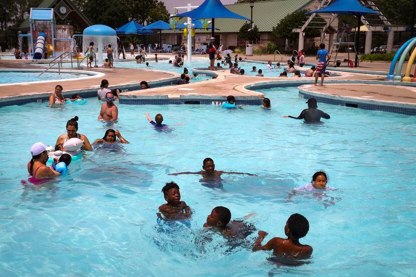 People swim in the pool Thursday, June 9, 2022, at Randol Mill Family Aquatic Center in...