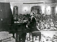 Van Cliburn performs for adoring fans at the Moscow Conservatory following his historic...