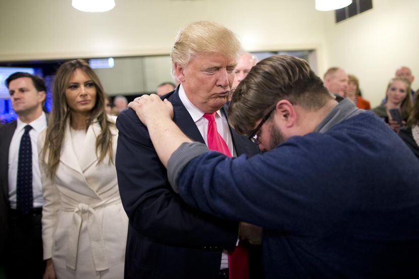 
Pastor Joshua Nink, right, prays for Republican presidential candidate Donald Trump, as...