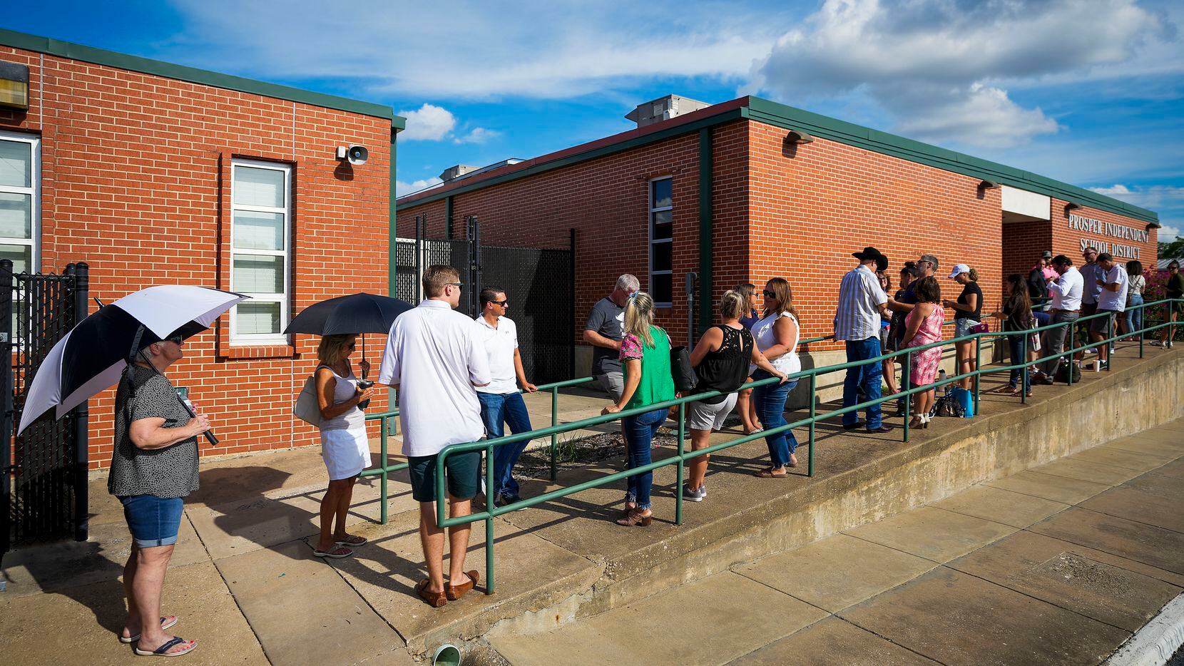 People stand in line to enter a Prosper ISD board meeting on Monday, Aug. 29, 2022, in...