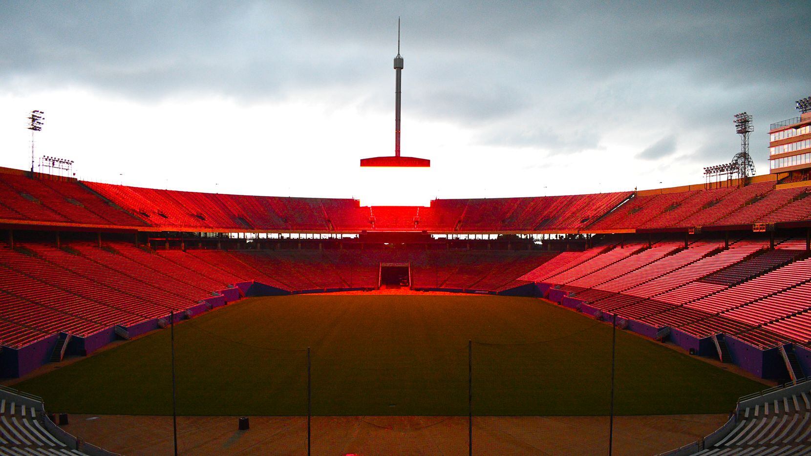 The scoreboard at Cotton Bowl Stadium at Fair Park glows red Sept. 1, 2020, as part of the...