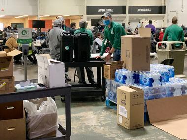 The scene inside the Fair Park Automobile Building on Feb. 3 as homeless advocates prepared to serve a meal for the unsheltered individuals who had sought refuge there during the winter storm.