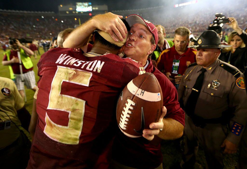 TALLAHASSEE, FL - OCTOBER 18:  Head coach Jimbo Fisher of the Florida State Seminoles hugs Jameis Winston #5 after defeating the Notre Dame Fighting Irish 31-27 in their game at Doak Campbell Stadium on October 18, 2014 in Tallahassee, Florida.  (Photo by Streeter Lecka/Getty Images) 10192014xSPORTS2