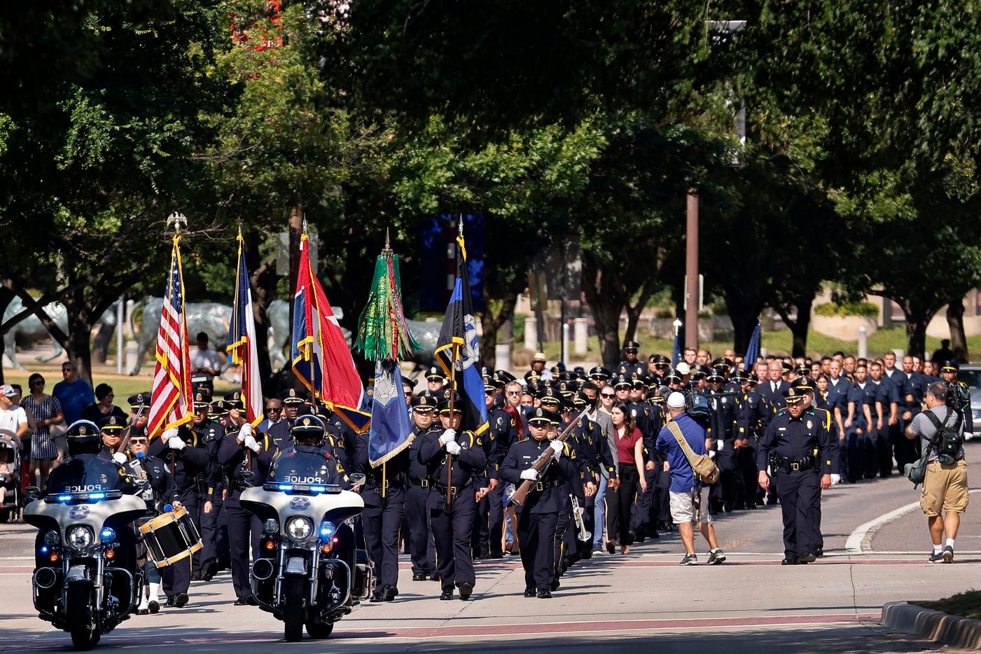 A procession of Dallas Police officers marches up Young Street to the 2021 Police Memorial Service at the DPD Memorial in downtown Dallas, Wednesday, July 7, 2021. It was the fifth anniversary of the July 7th ambush and special recognition was given to those officers who were killed. (Tom Fox/The Dallas Morning News)