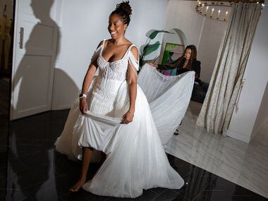 Adenieki Mornan walks toward the showroom after trying on her wedding dress to be tailored...