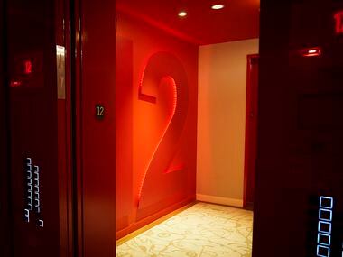 A view from the red-hued elevators out to the red-hued floor numbers at the new the Virgin...