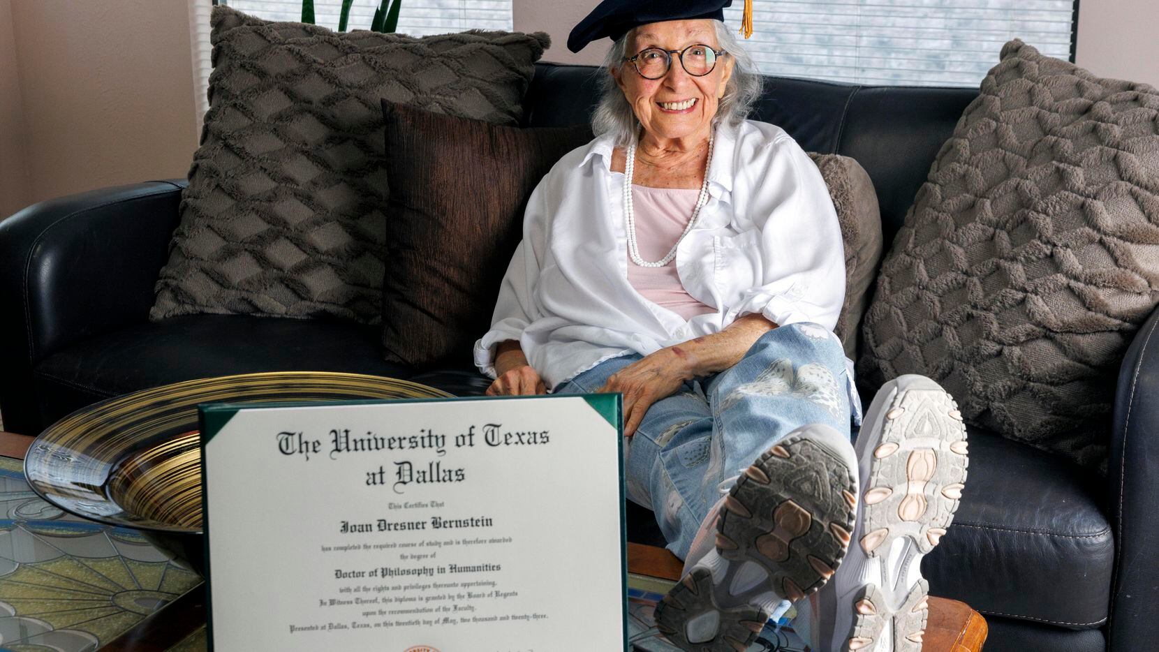 Joan Bernstein, 88, wears her tam from her doctoral hooding ceremony alongside her doctor of...