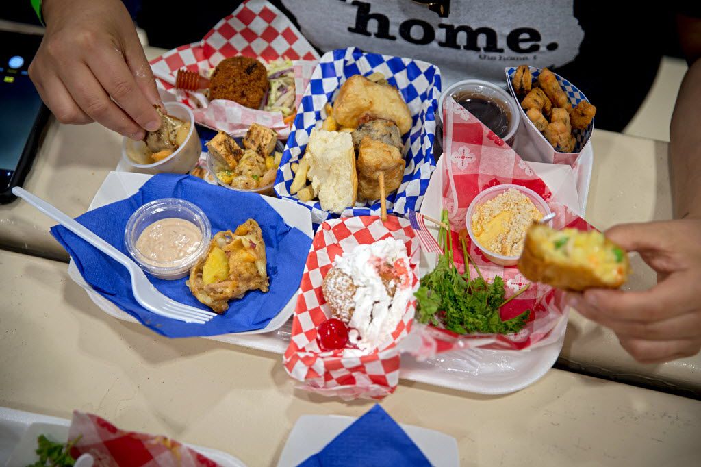 A fan consumes a tray full of entries during the 2016 Big Tex Choice Awards Sunday, August 28, 2016 at Fair Park in Dallas. The annual event, held ahead of the State Fair of Texas, recognizes the best fried foods entered into consideration for sale at the fair. (G.J. McCarthy/The Dallas Morning News)