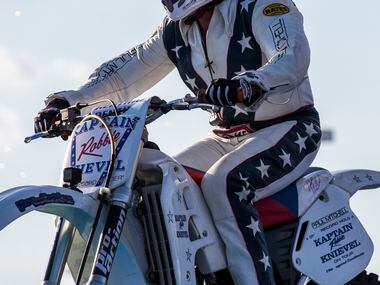Daredevil Robbie Knievel lands after he jumps over 18 Corvettes on a motorcycle during a...