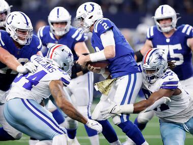 Dallas Cowboys defensive tackle Osa Odighizuwa (97) sacks Indianapolis Colts quarterback...