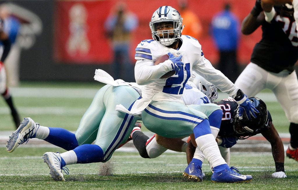 Dallas Cowboys running back Ezekiel Elliott (21) spins around Dallas Cowboys tight end...