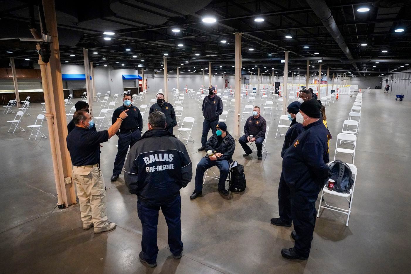 Richard Esparza of Dallas County Health and Human Services briefs Dallas Fire Rescue personnel before the doors to open for people to receive the COVID-19 vaccine at Fair Park on Monday, Jan. 11, 2021, in Dallas. Dallas County launched its first “mega” public COVID-19 vaccination site Monday at Fair Park.