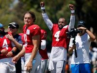 Dallas Cowboys quarterback Dak Prescott (4) raises arms thinking the throw by Los Angeles...