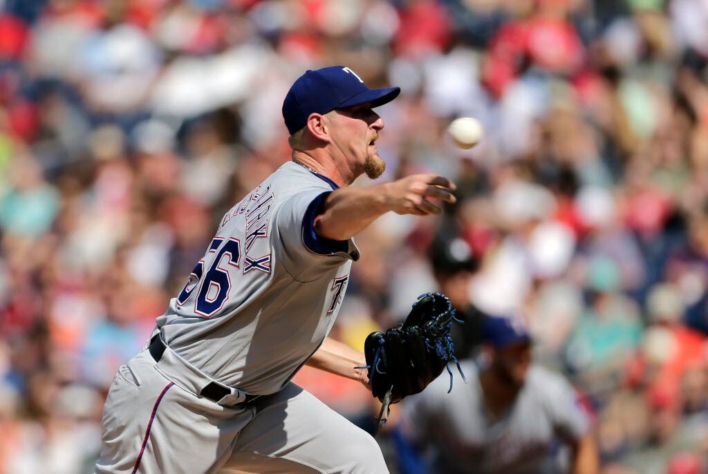 Texas Rangers starting pitcher Austin Bibens-Dirkx throws during the first inning of a baseball game against the Washington Nationals, Sunday, June 11, 2017, in Washington. (AP Photo/Mark Tenally)
