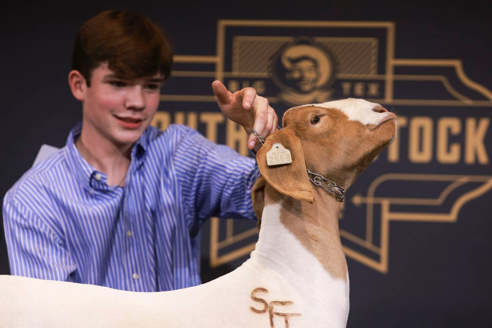 Madden Wise holds his Grand Champion market goat Friday at the State Fair of Texas.