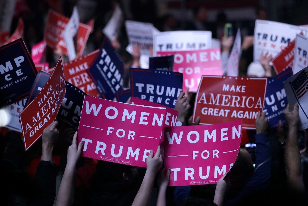 Supporters hold "Women for Trump" signs before a campaign rally for Republican presidential...