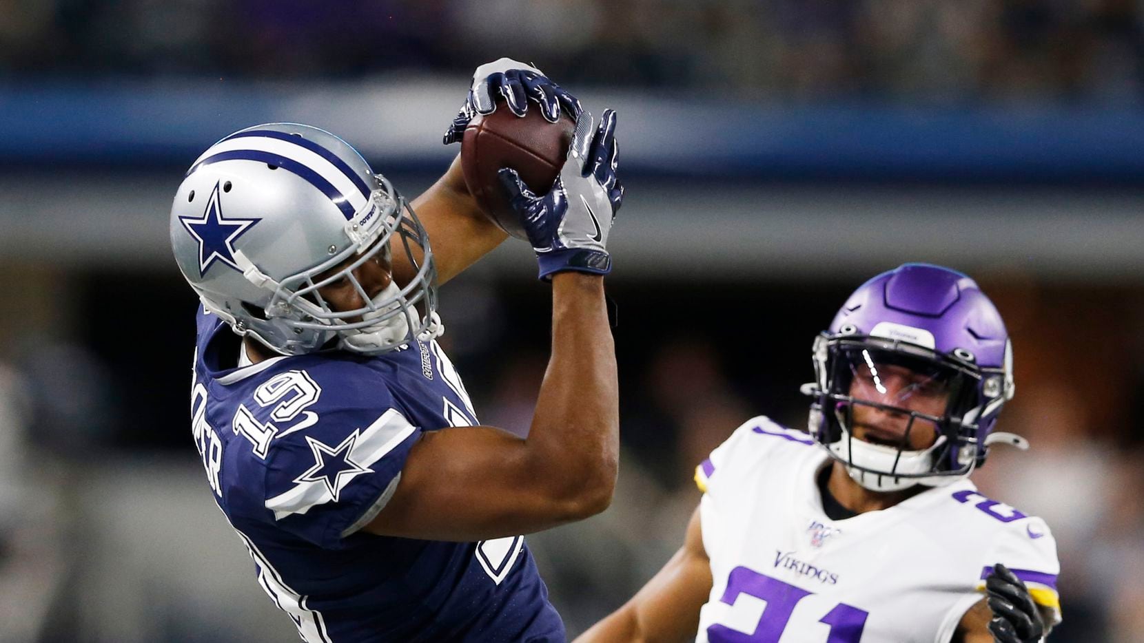 Dallas Cowboys wide receiver Amari Cooper (19) makes a catch in front of Minnesota Vikings cornerback Mike Hughes (21) for a first down during the first half of play at AT&T Stadium in Arlington, Texas on Sunday, November 10, 2019. (Vernon Bryant/The Dallas Morning News)