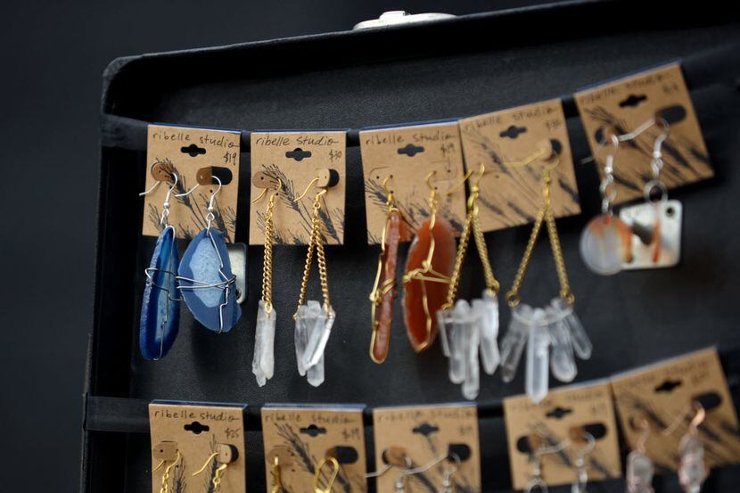 Handcrafted earrings are on display during a Garland market.