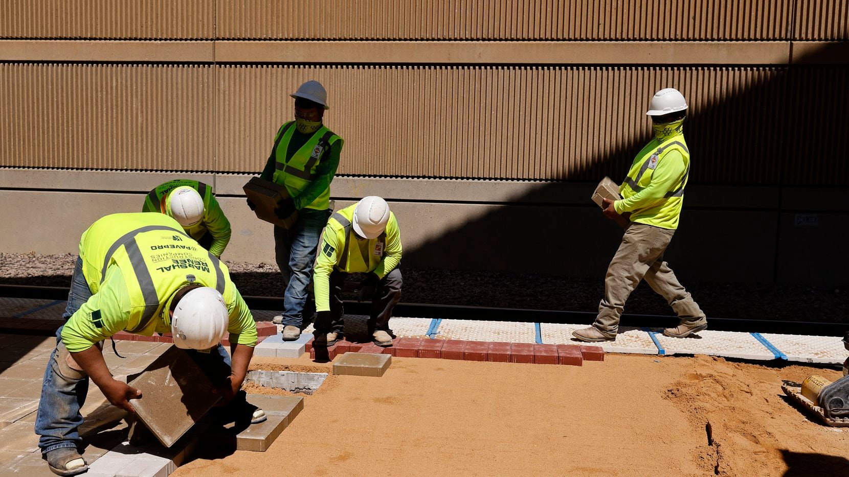 Construction workers remake the platform at DART's Mockingbird Station during U.S....