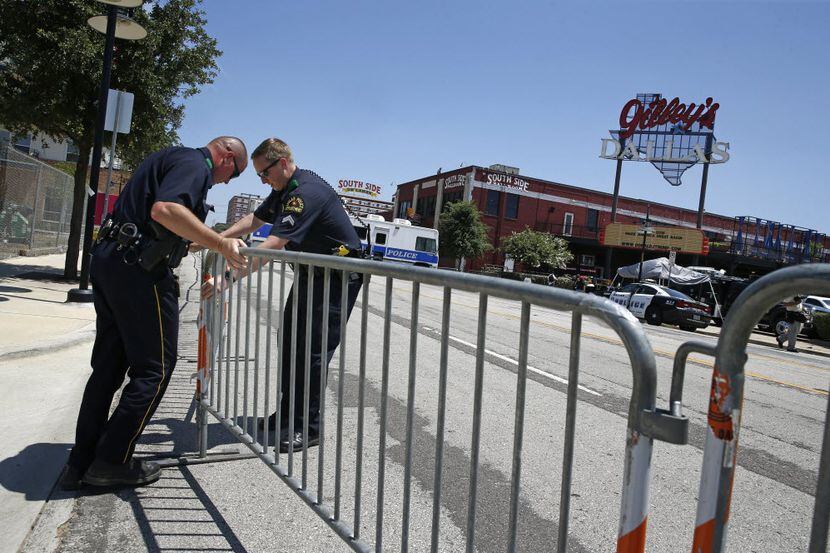 Dallas police officers set up barricades hours before the Donald Trump campaign rally at...