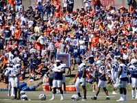  Denver Broncos and Dallas Cowboys fans line the hillside to watch a joint practice at the...