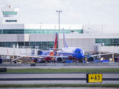 Southwest Airlines airplanes are parked at terminals while computer systems recover from a...