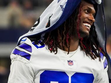 Dallas Cowboys wide receiver CeeDee Lamb laughs on the bench during the fourth quarter of...