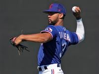 Texas Rangers Leody Taveras throws during spring training baseball practice Monday, Feb. 20,...