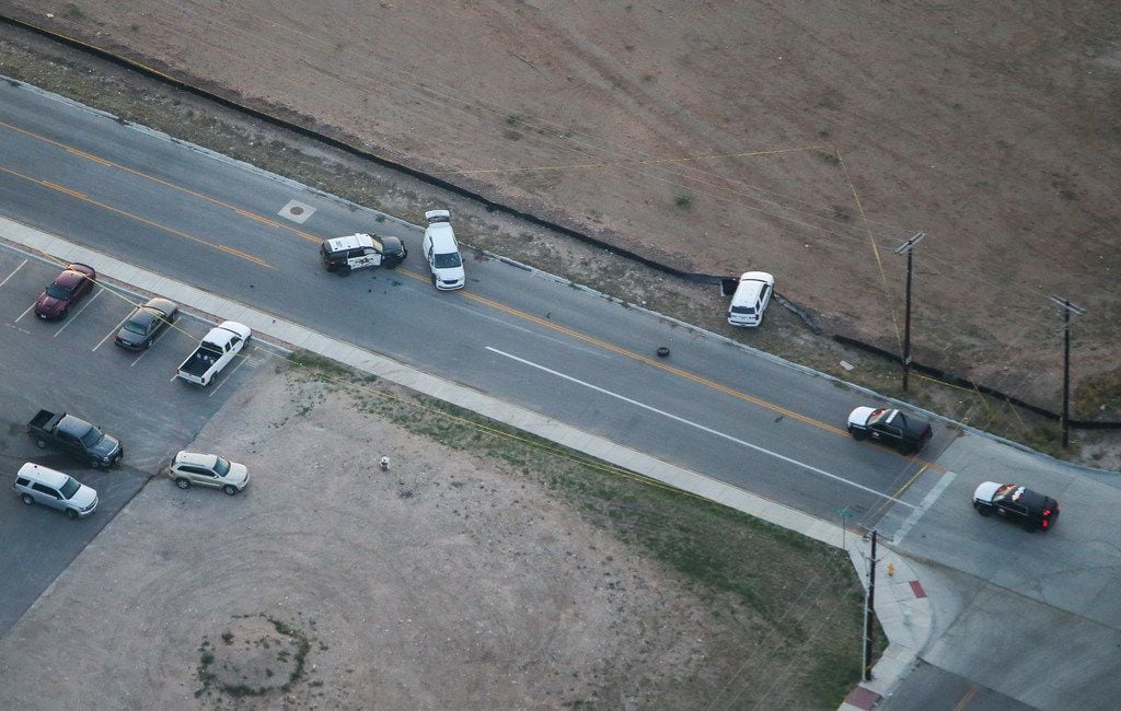 A crashed U.S. Postal Service vehicle and an Odessa police vehicle are seen Sunday at a...