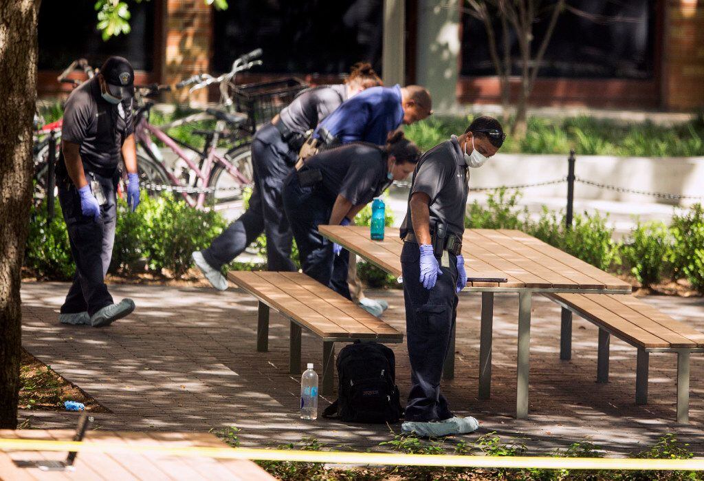 In this May 1 photo, officials investigate the fatal stabbing attack at the University of...