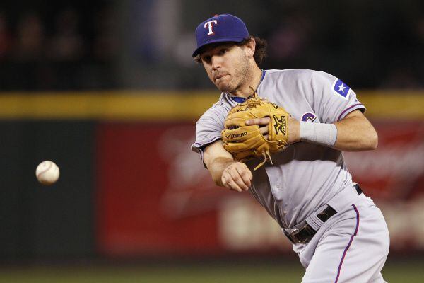 Sept. 16: Second baseman Ian Kinsler throws wide to first for an error on a ground ball from...