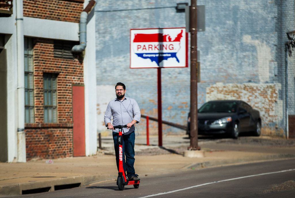A man rides an electric scooter on Young Street in Dallas on Wednesday, December 4, 2019....