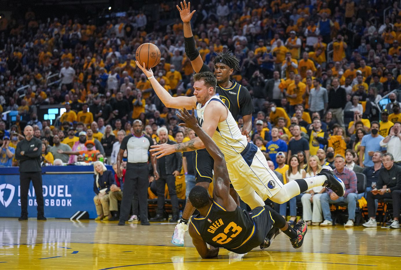 Dallas Mavericks guard Luka Doncic (77) is fouled by Golden State Warriors forward Draymond...