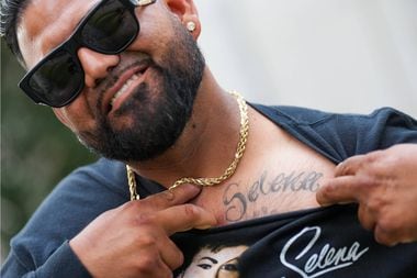 Oscar Contreras of Arlington shows off his Selena tattoos during a celebration of the life...