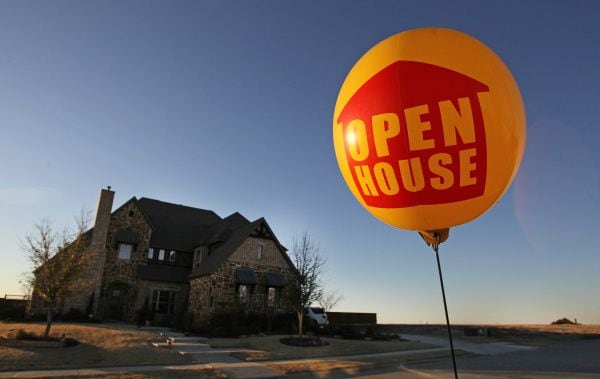 Open land beckons in the distance as a balloon advertises an open house in the Saddle Creek Estates development in Prosper.