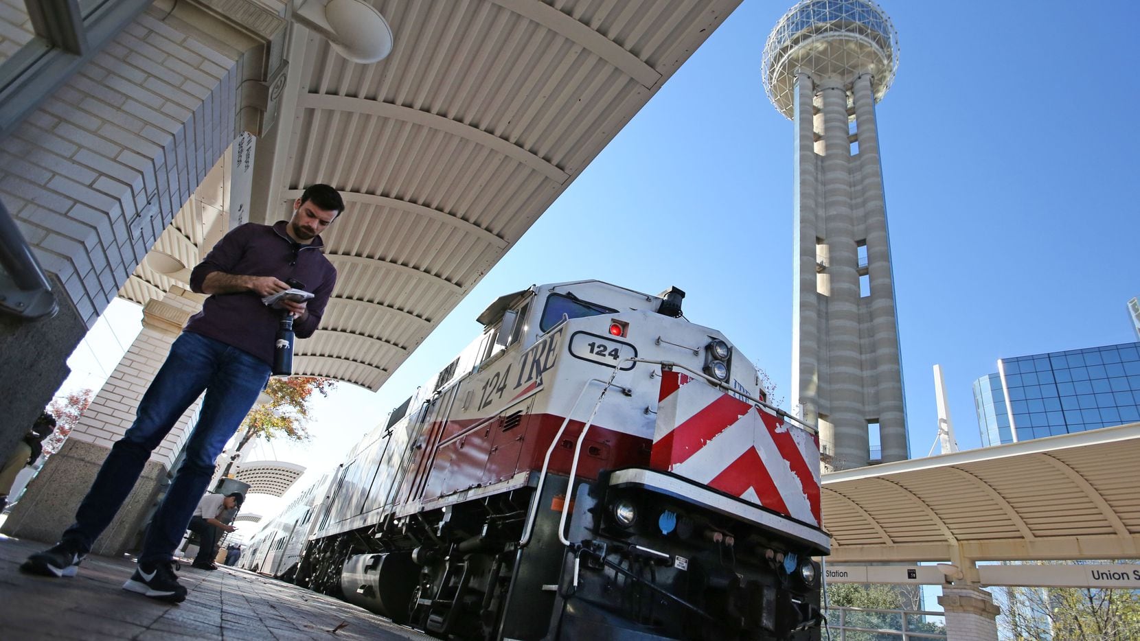 Dallas Morning News reporter Brendan Meyer waits to board the TRE train at Union Station as...