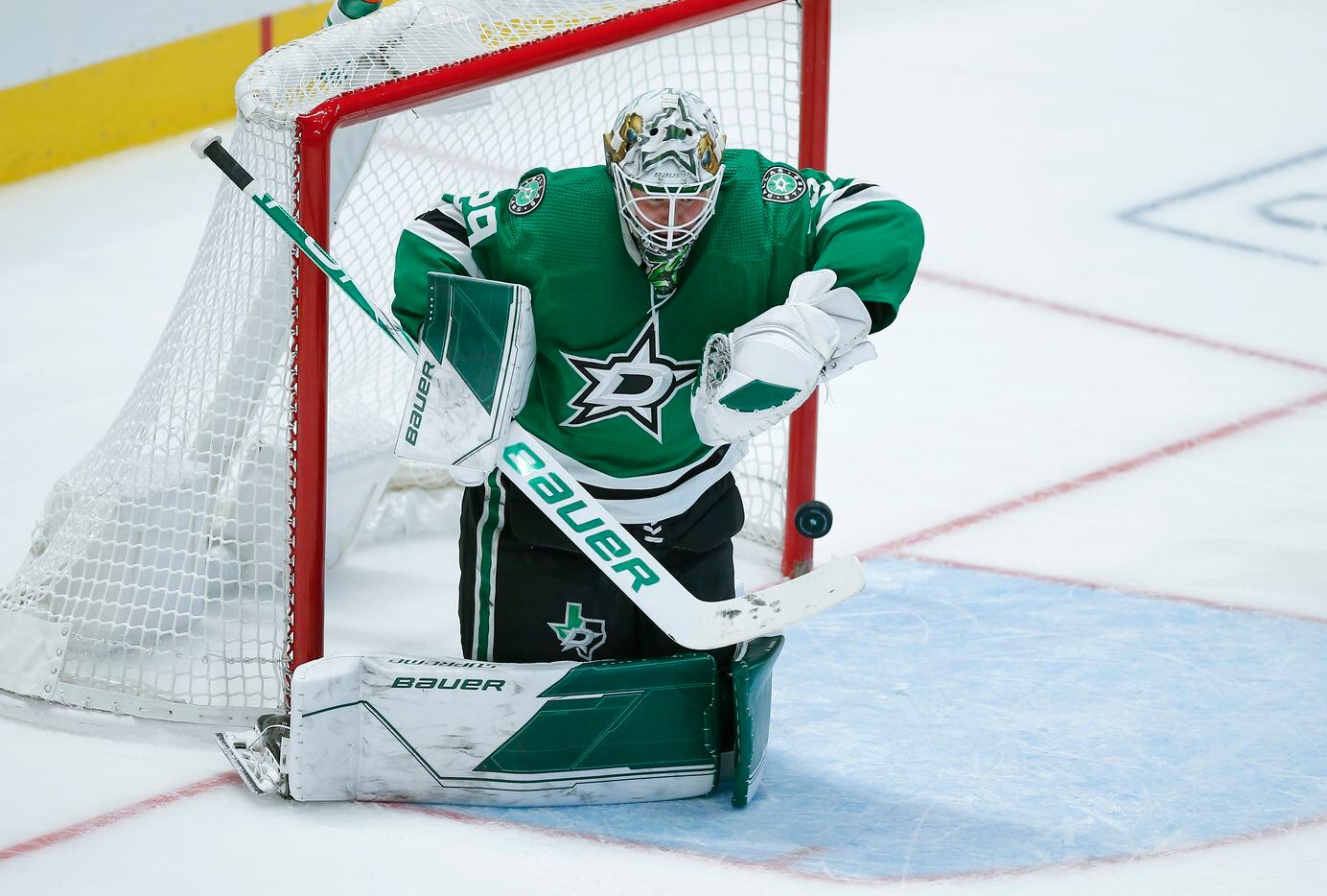 Dallas Stars goaltender Jake Oettinger (29) gives up a goal to Detroit Red Wings forward Dylan Larkin during the second period of an NHL hockey game, Tuesday, November 16, 2021. (Brandon Wade/Special Contributor)