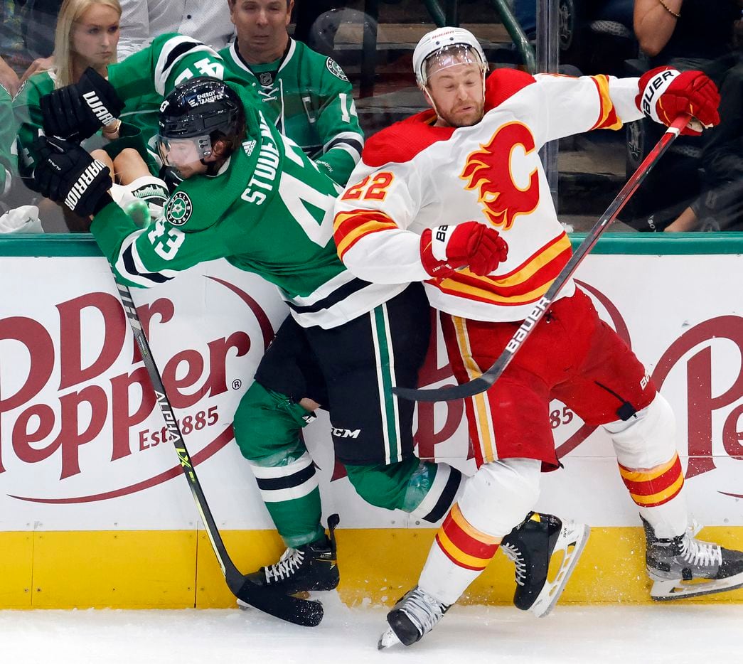 Dallas Stars left wing Marian Studenic (43) is chocked against the boards by Calgary Flames...