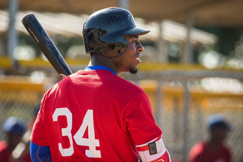 Cuban outfield Julio Pablo Martinez hits in a tryout game during a camp at the Rangers' Dominican Republic baseball academy complex on Monday, Jan. 22, 2018, in Boca Chica, Dominican Republic.  (Smiley N. Pool/The Dallas Morning News)