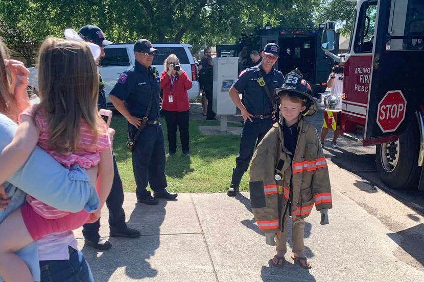Carter Woodruff, 7, tries on an Arlington Fire uniform on Tuesday, May 19, 2020, in...