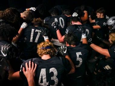 Denton Guyer players pray in the tunnel before a Class 6A Division II area-round high school...