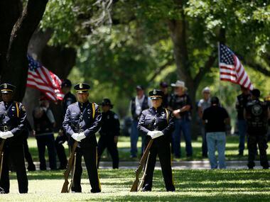 The Honor Guard stands at the burial for fallen Dallas police officer Lorne Ahrens in the...
