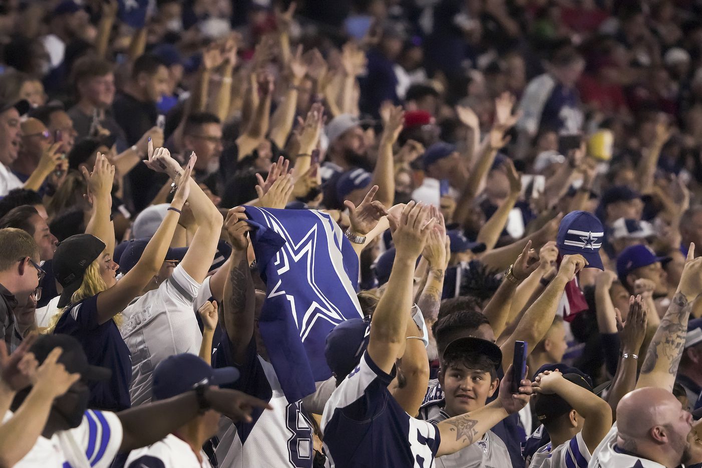 Dallas Cowboys fans cheer their team during the second half of a preseason NFL football game against the Arizona Cardinals at State Farm Stadium on Friday, Aug. 13, 2021, in Glendale, Ariz.
