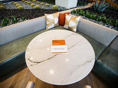A sign notifies guests that a table is closed in an effort to promote social distancing to...