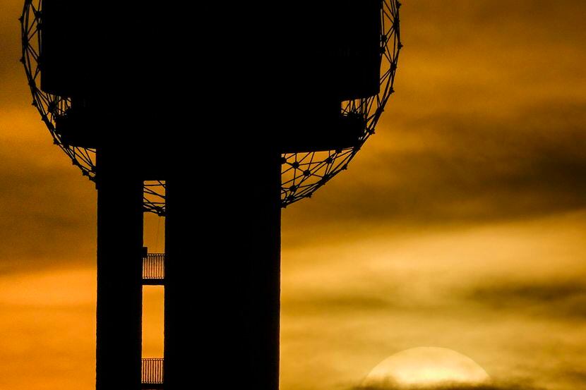 The sun sets behind Reunion Tower in Dallas. 