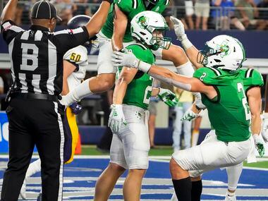 Southlake Carroll running back James Lehman (20) celebrates with wide receiver Owen Ohser...