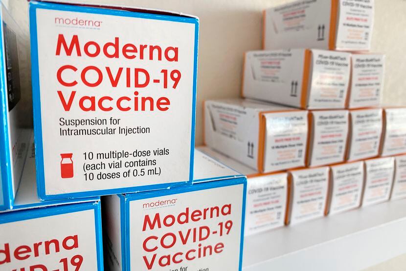 Used boxes of Moderna and Pfizer-BioTech COVID-19 vaccines are on display at a Hurst pharmacy.