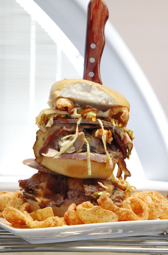 The Wicked Pig is a Hawaiian roll layered with pulled pork, bacon, sausage, prosciutto and...