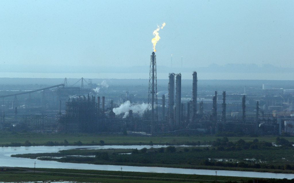 A flare stack puts out a flame at a refinery near an area hit by floodwaters from Tropical...